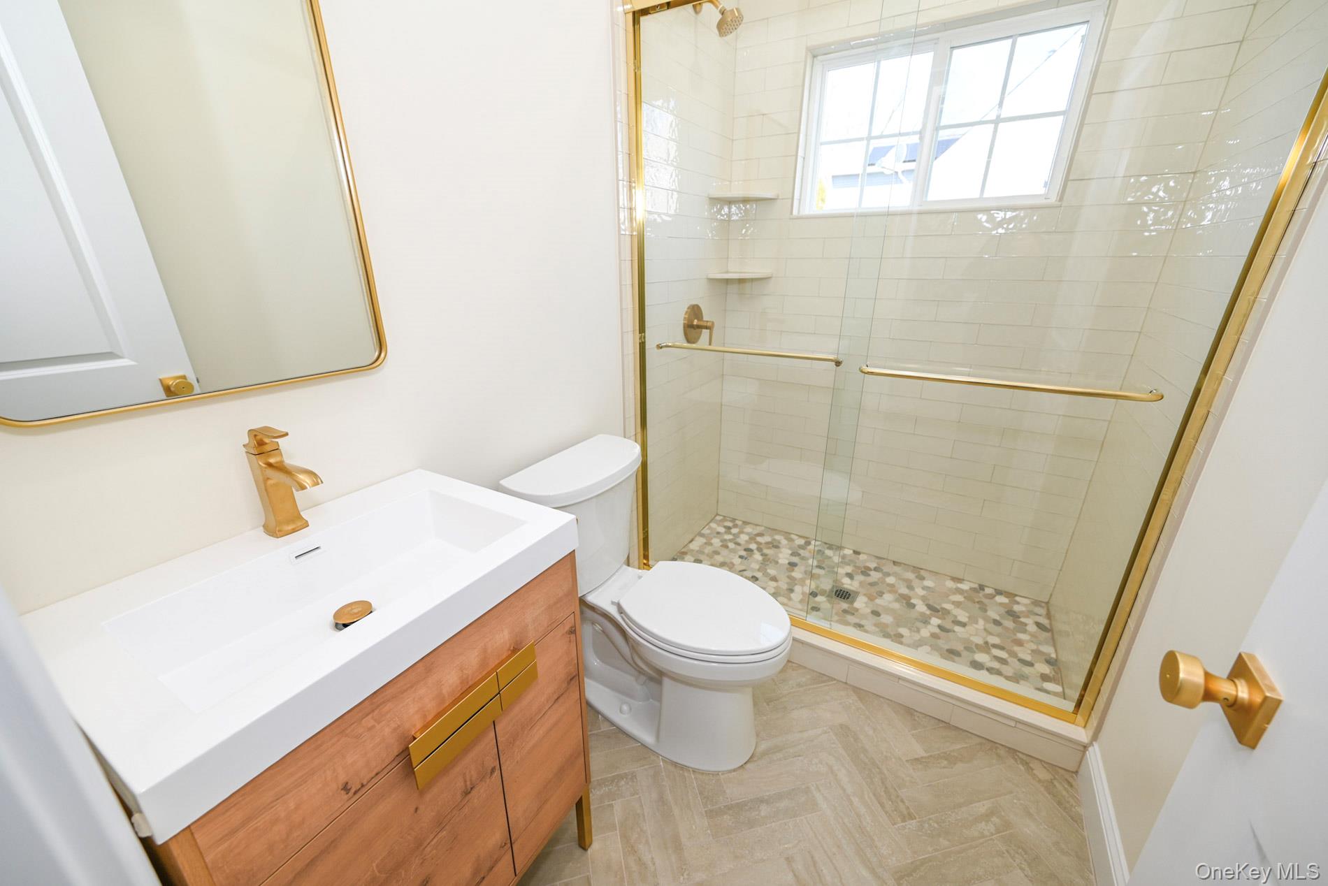 1772 Rose Street Merrick, NY 11566 - Photo 10 of 35 a bathroom with a sink a toilet and shower