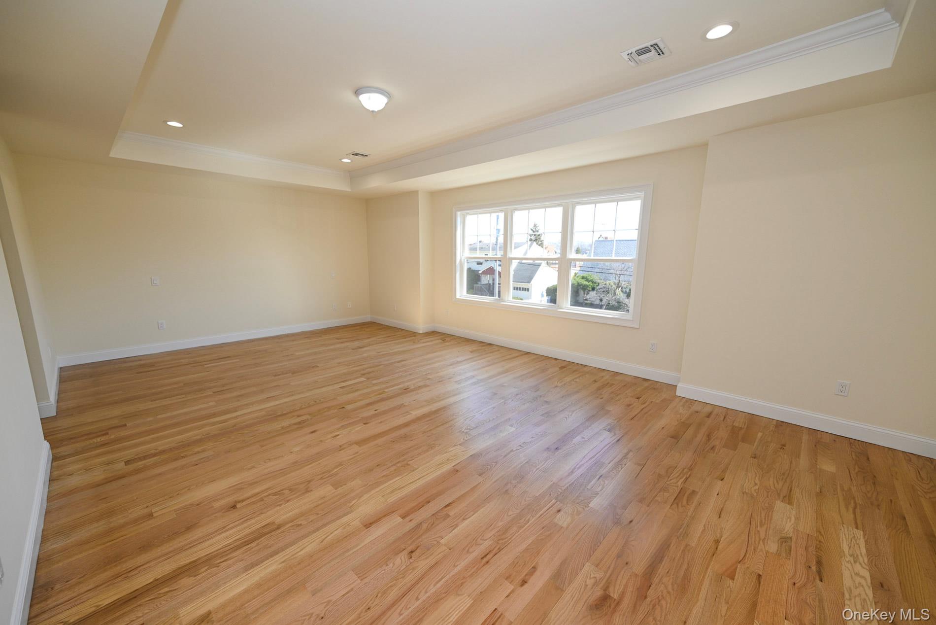 1772 Rose Street Merrick, NY 11566 - Photo 13 of 35 an empty room with wooden floor and windows
