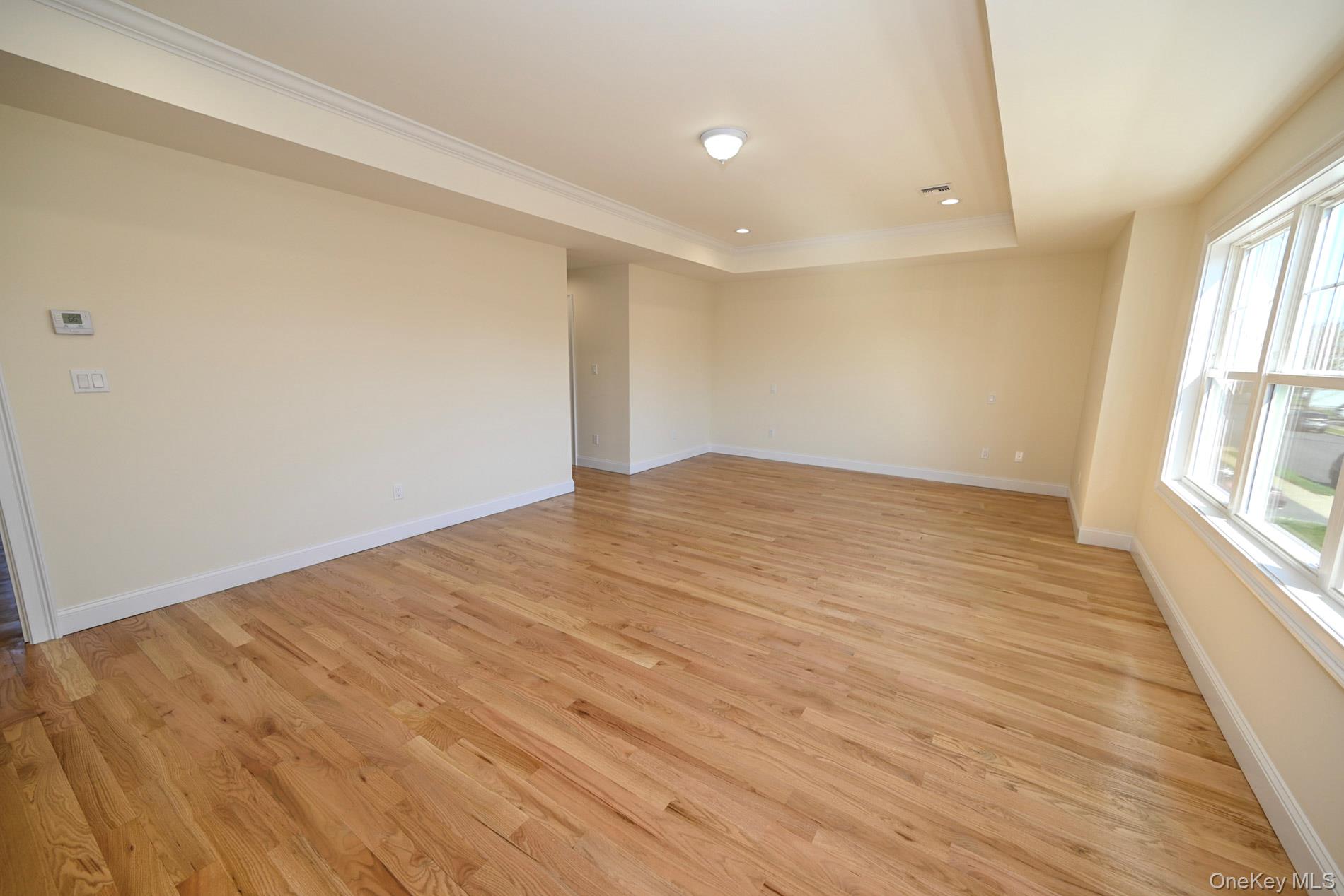 1772 Rose Street Merrick, NY 11566 - Photo 14 of 35 wooden floor in an empty room with a window