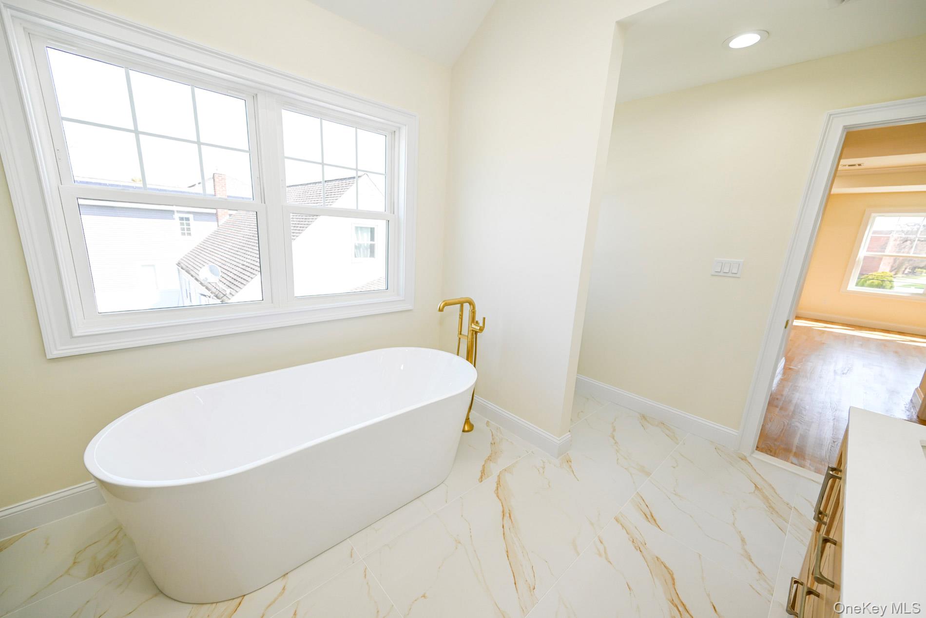 1772 Rose Street Merrick, NY 11566 - Photo 17 of 35 a white bath tub sitting next to a window
