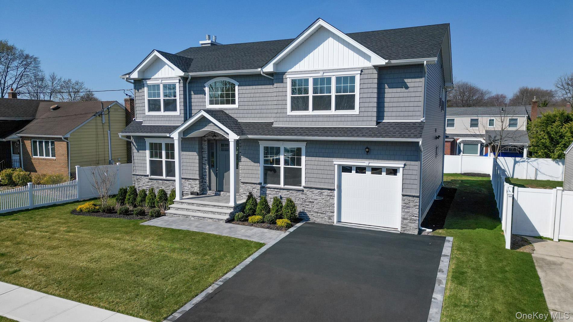 1772 Rose Street Merrick, NY 11566 - Photo 2 of 35 a front view of a house with a yard