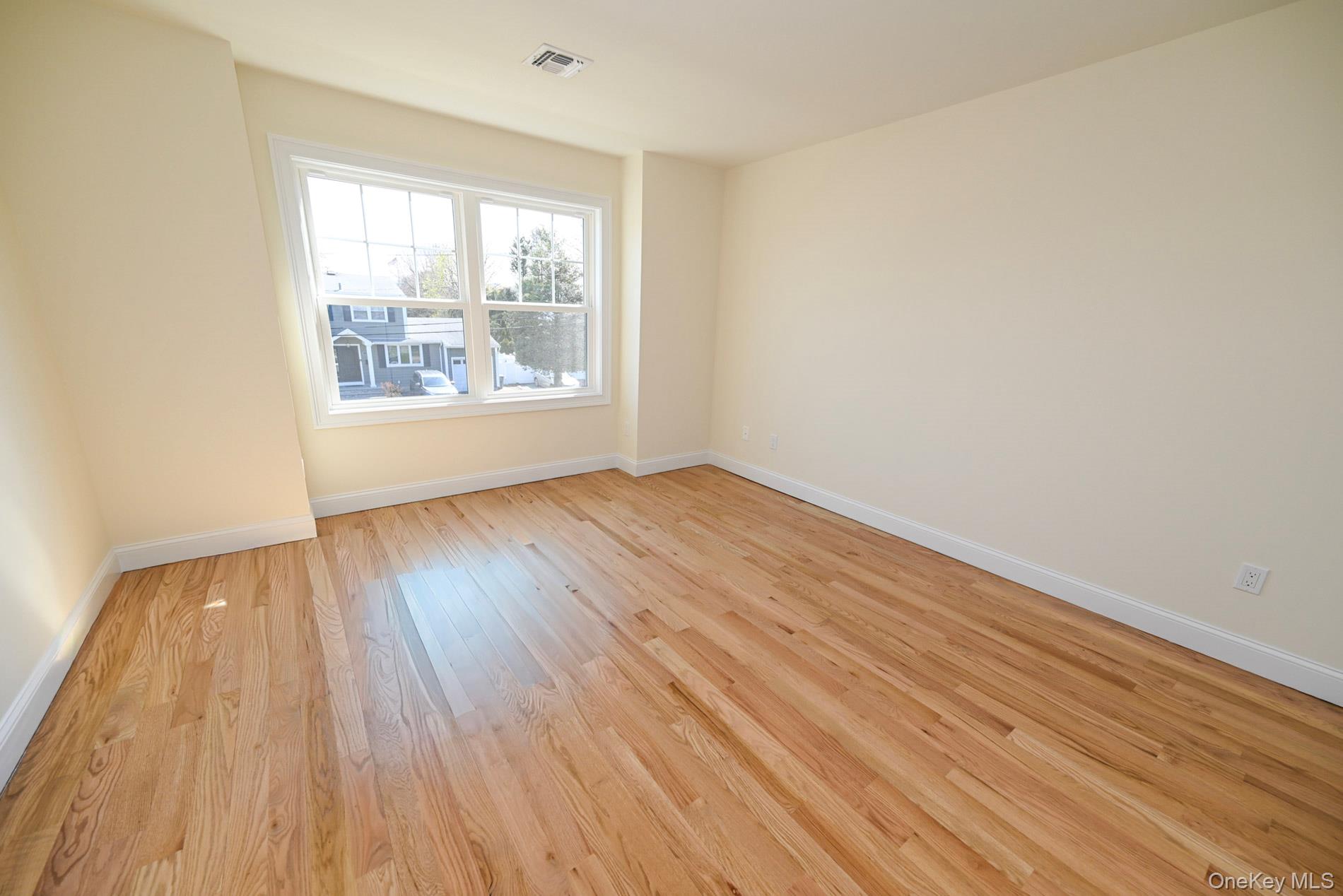 1772 Rose Street Merrick, NY 11566 - Photo 22 of 35 an empty room with wooden floor and windows