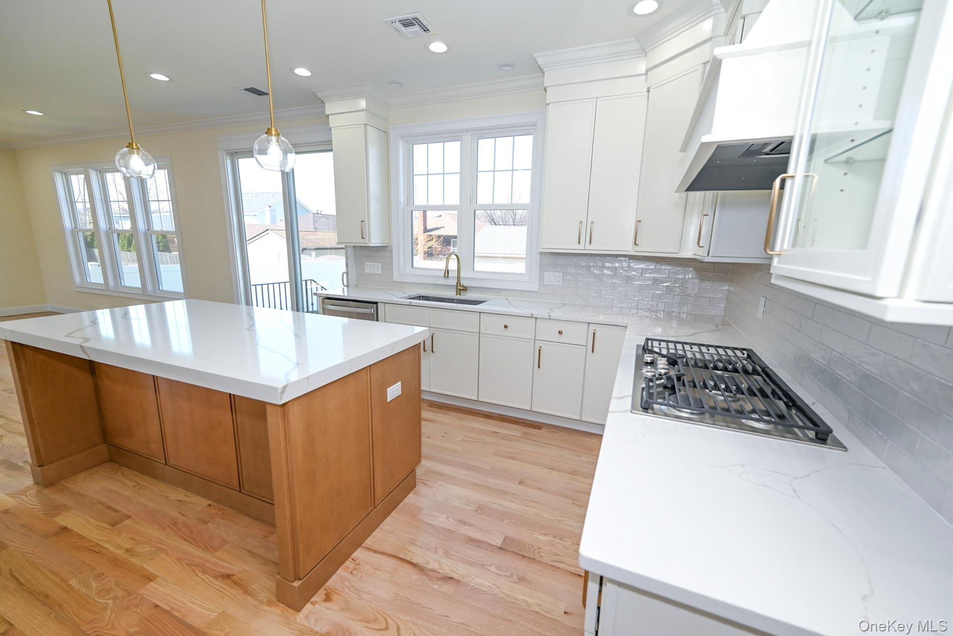 1772 Rose Street Merrick, NY 11566 - Photo 7 of 35 a kitchen with stainless steel appliances granite countertop a sink a stove and a refrigerator