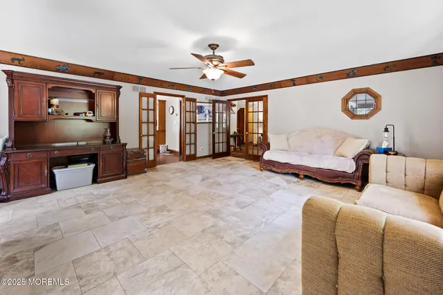 a kitchen with stainless steel appliances a stove a sink dishwasher and a dining table with wooden floor