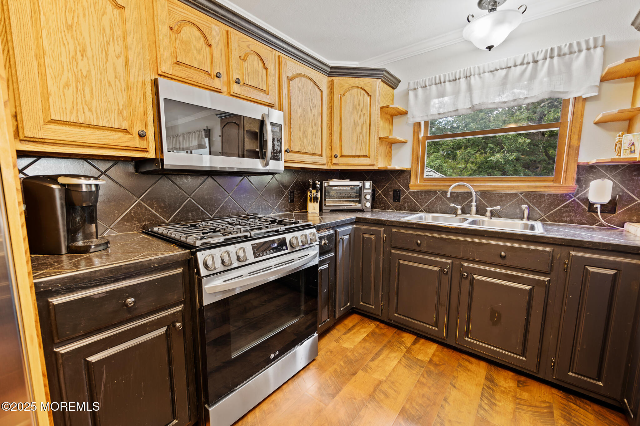 1069 East Veterans Highway Jackson, NJ 08527 - Photo 19 of 65 a kitchen with stainless steel appliances granite countertop a sink stove and microwave