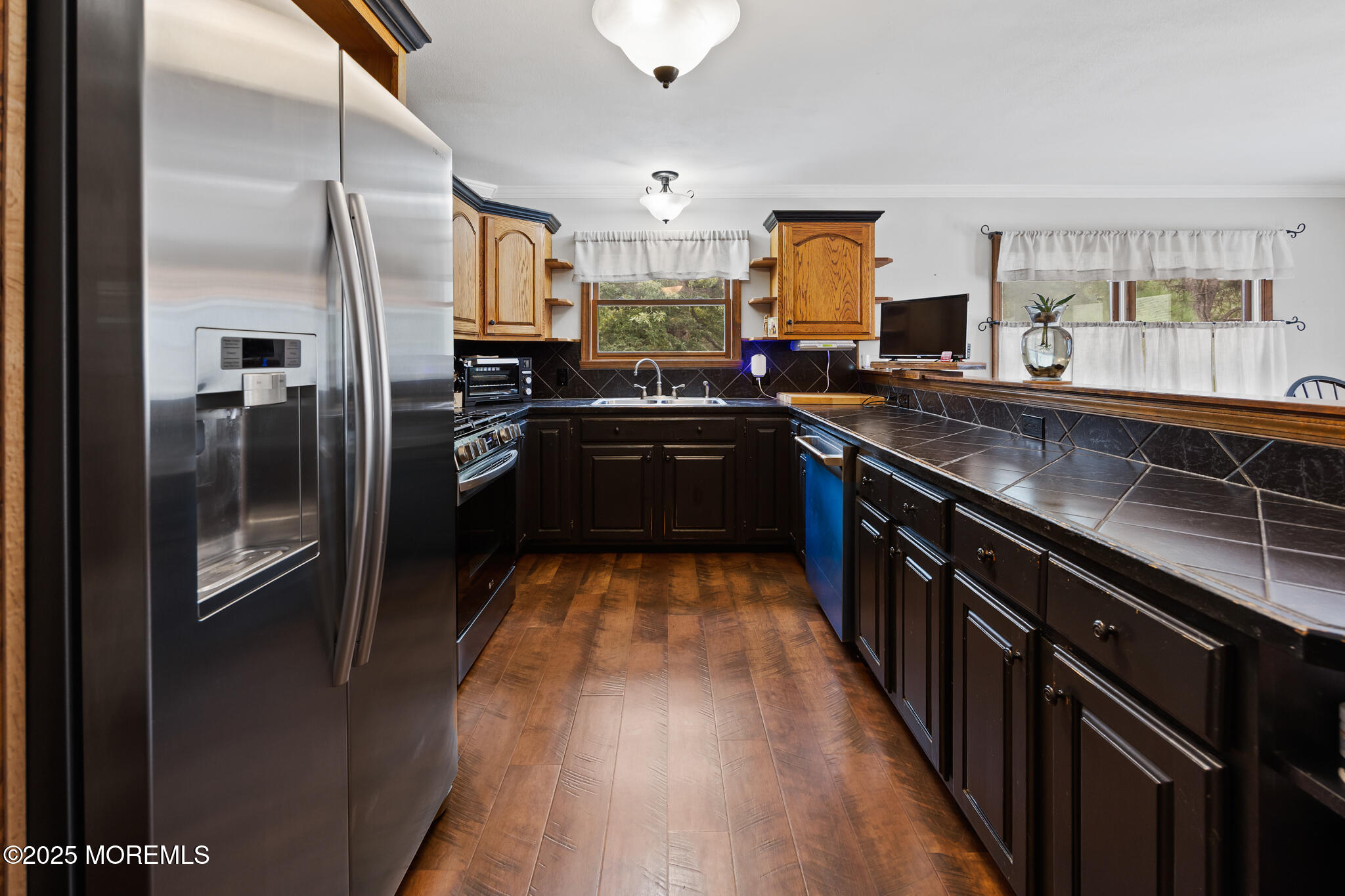 1069 East Veterans Highway Jackson, NJ 08527 - Photo 20 of 65 a kitchen with stainless steel appliances granite countertop a refrigerator a sink dishwasher a oven with wooden cabinets and floor