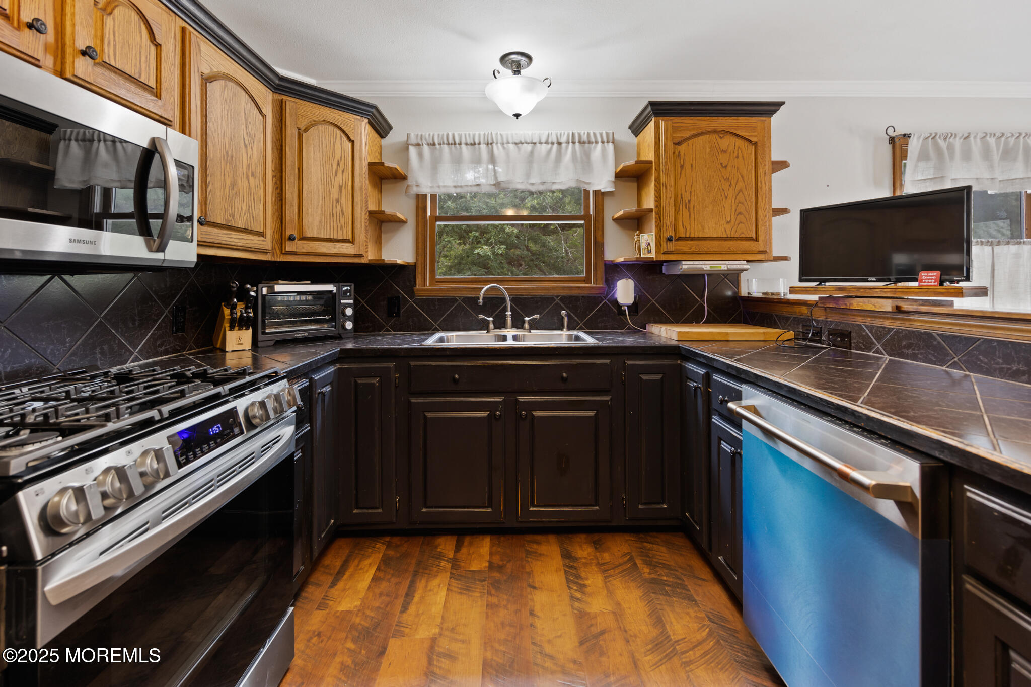1069 East Veterans Highway Jackson, NJ 08527 - Photo 2 of 65 a kitchen with a sink stove and microwave
