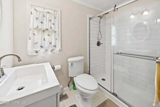 a view of a hallway with wooden floor and a living room