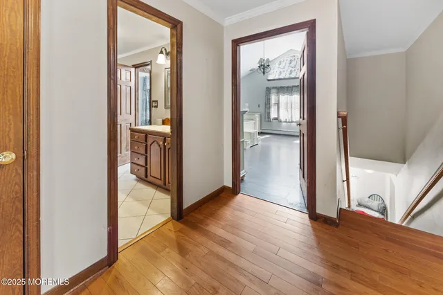 a view of an empty room with window and furniture
