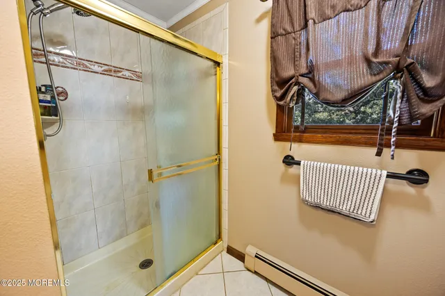 an aerial view of residential houses with outdoor space and trees