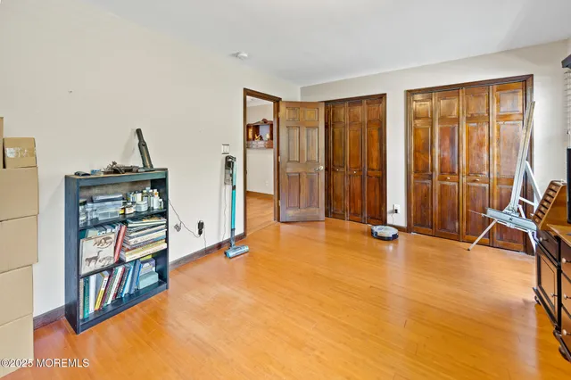 an aerial view of residential house with outdoor space and trees all around