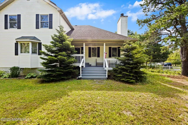 a view of living room with furniture and a fireplace
