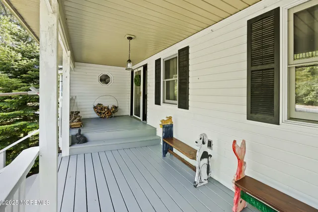 a living room with furniture flowerpot and wooden floor