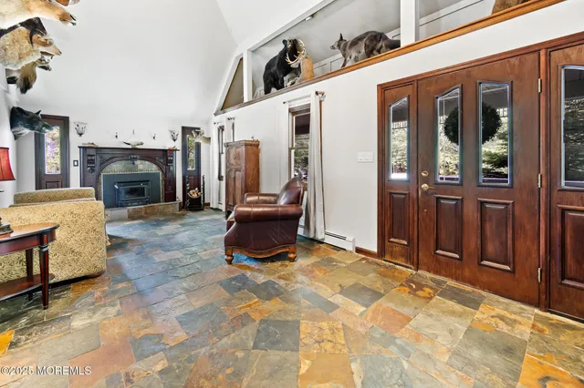 a living room with furniture a flat screen tv and a large window