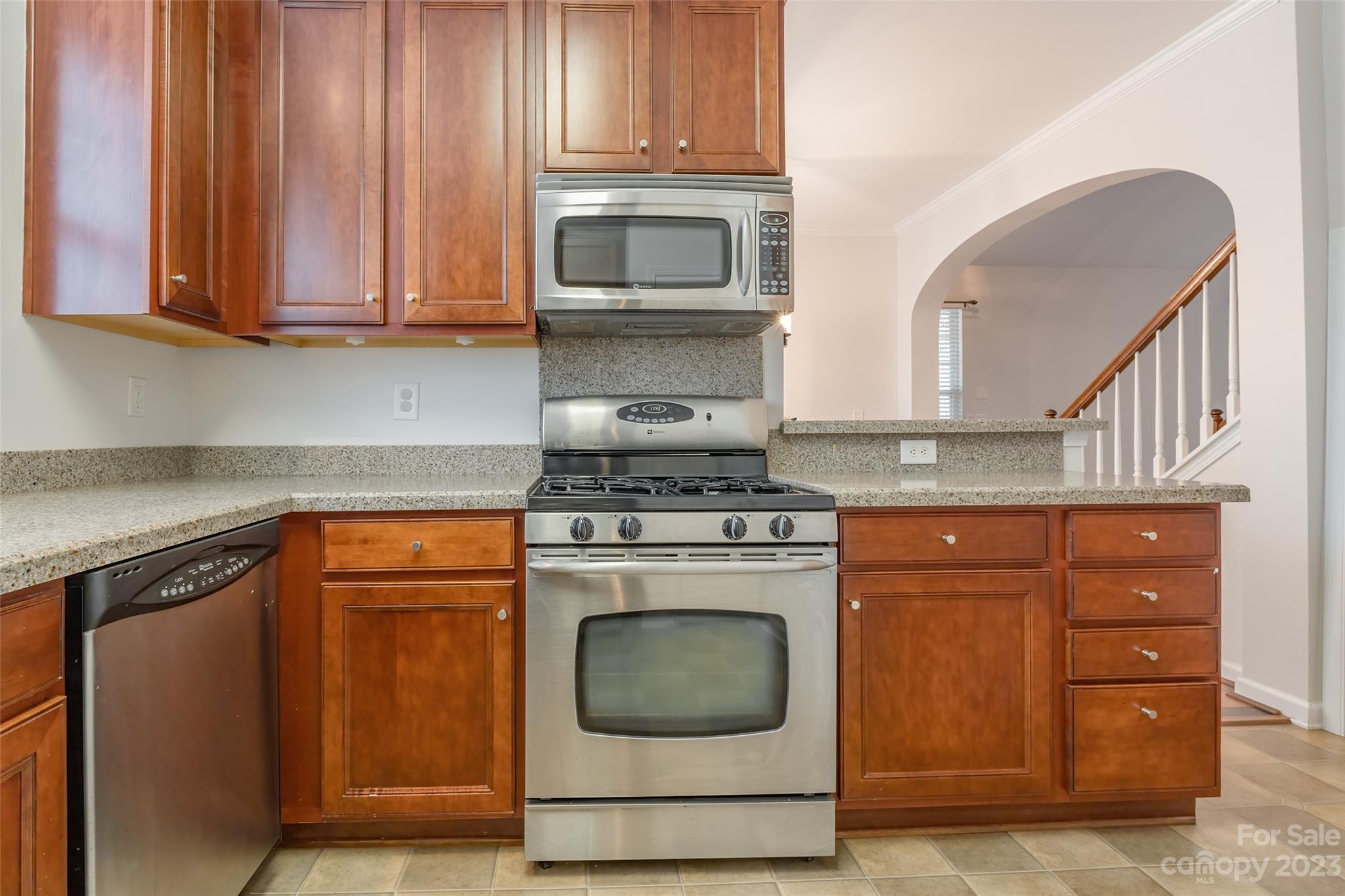 903 Copperstone Lane Fort Mill, SC 29708 - Photo 6 of 17 a kitchen with granite countertop wood cabinets and a stove top oven