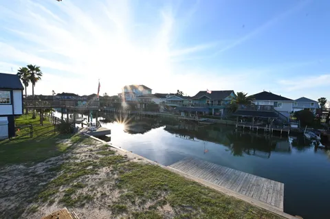 a living room with furniture a rug and a floor to ceiling window
