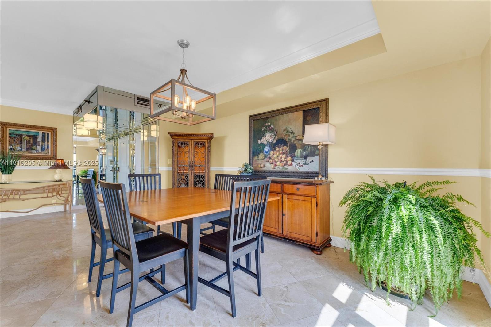 2000 Towerside Terrace, Unit 702 Miami, FL 33138 - Photo 13 of 37 a dining room with furniture and a chandelier