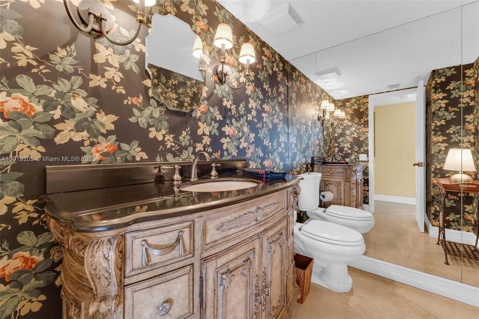 2000 Towerside Terrace, Unit 702 Miami, FL 33138 - Photo 21 of 37 a bathroom with a toilet sink and mirror