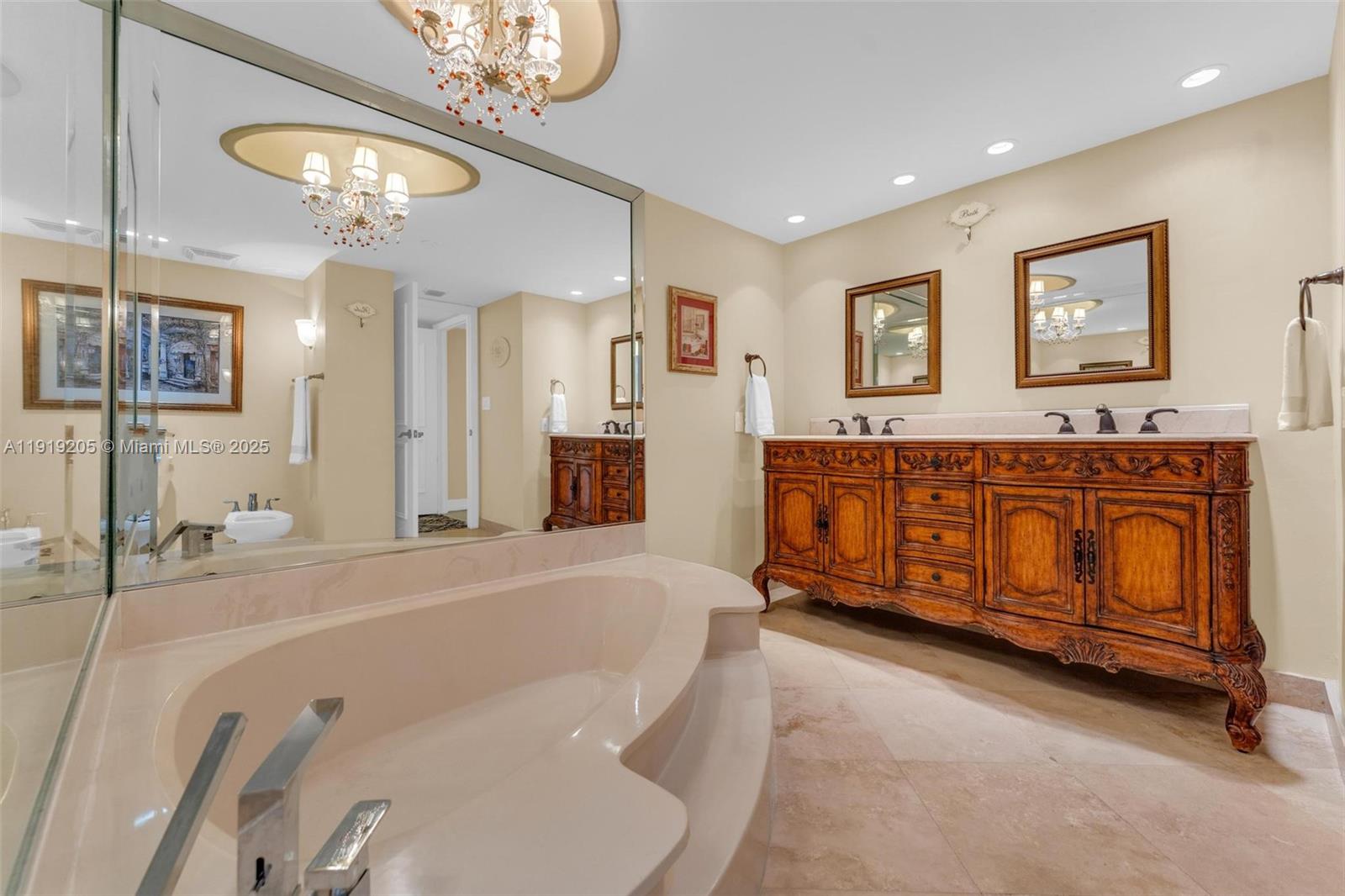 2000 Towerside Terrace, Unit 702 Miami, FL 33138 - Photo 23 of 37 a spacious bedroom with a bed and a chandelier