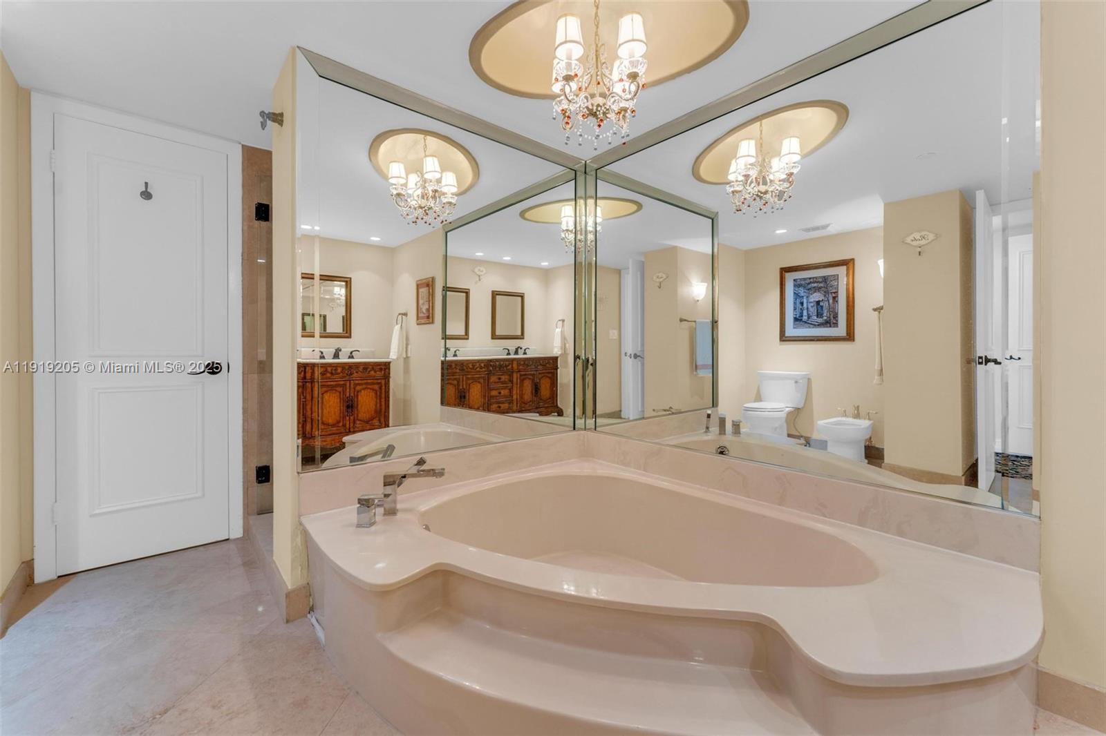 2000 Towerside Terrace, Unit 702 Miami, FL 33138 - Photo 25 of 37 a spacious bathroom with a tub sink and a mirror