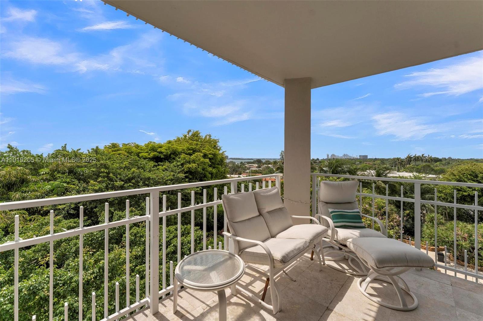 2000 Towerside Terrace, Unit 702 Miami, FL 33138 - Photo 32 of 37 a view of a balcony with couches and wooden floor