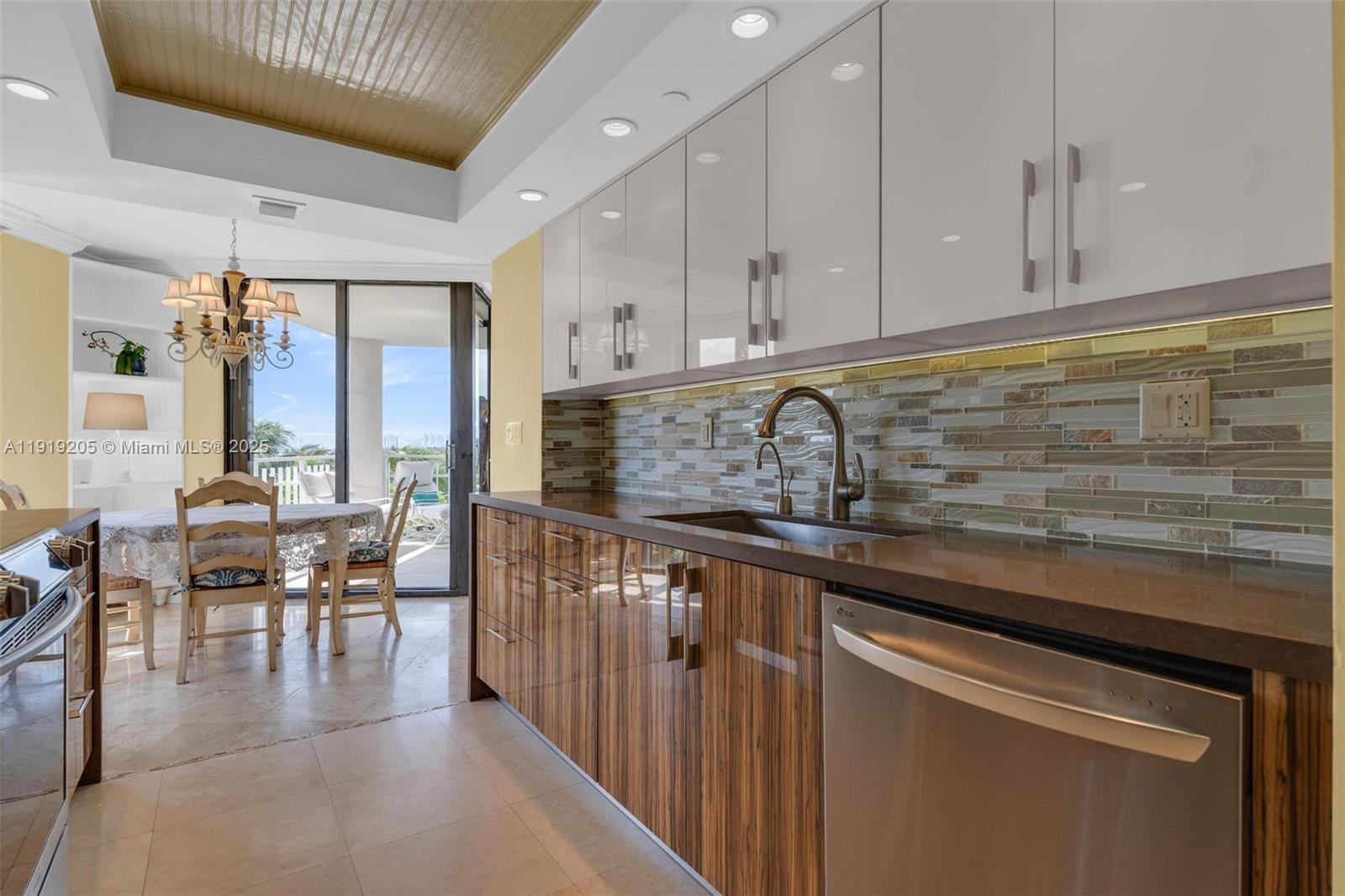 2000 Towerside Terrace, Unit 702 Miami, FL 33138 - Photo 6 of 37 a kitchen with stainless steel appliances granite countertop a stove a sink and white cabinets
