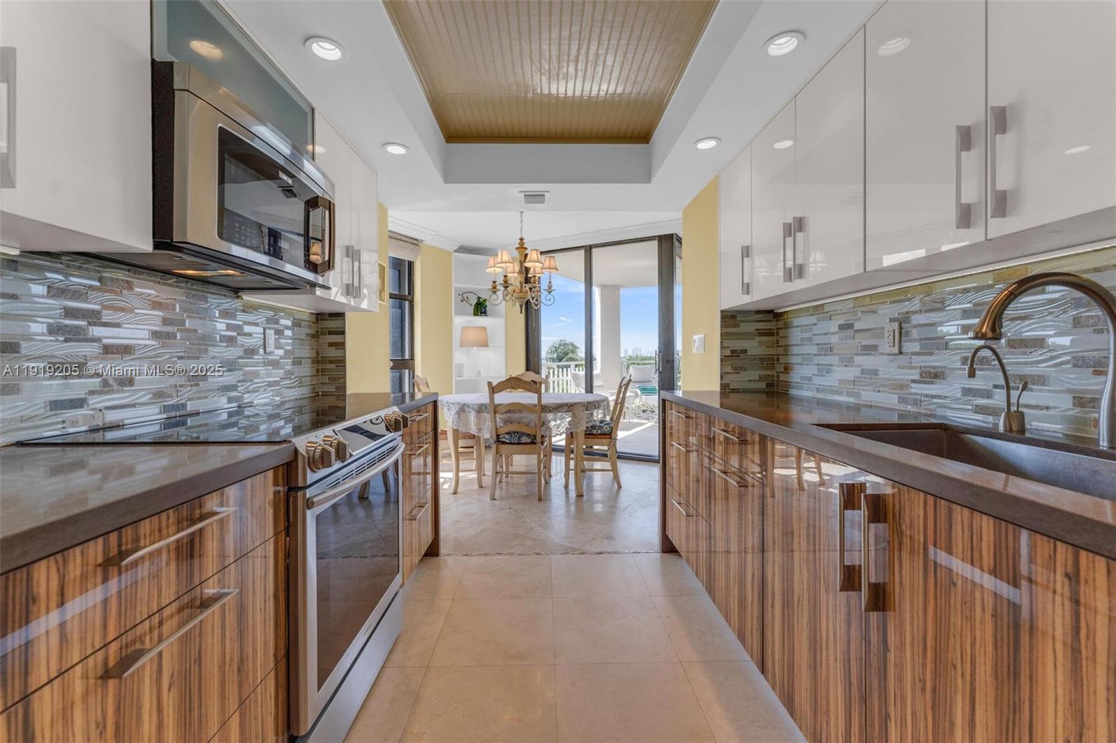 2000 Towerside Terrace, Unit 702 Miami, FL 33138 - Photo 7 of 37 a kitchen with stainless steel appliances granite countertop a sink and cabinets