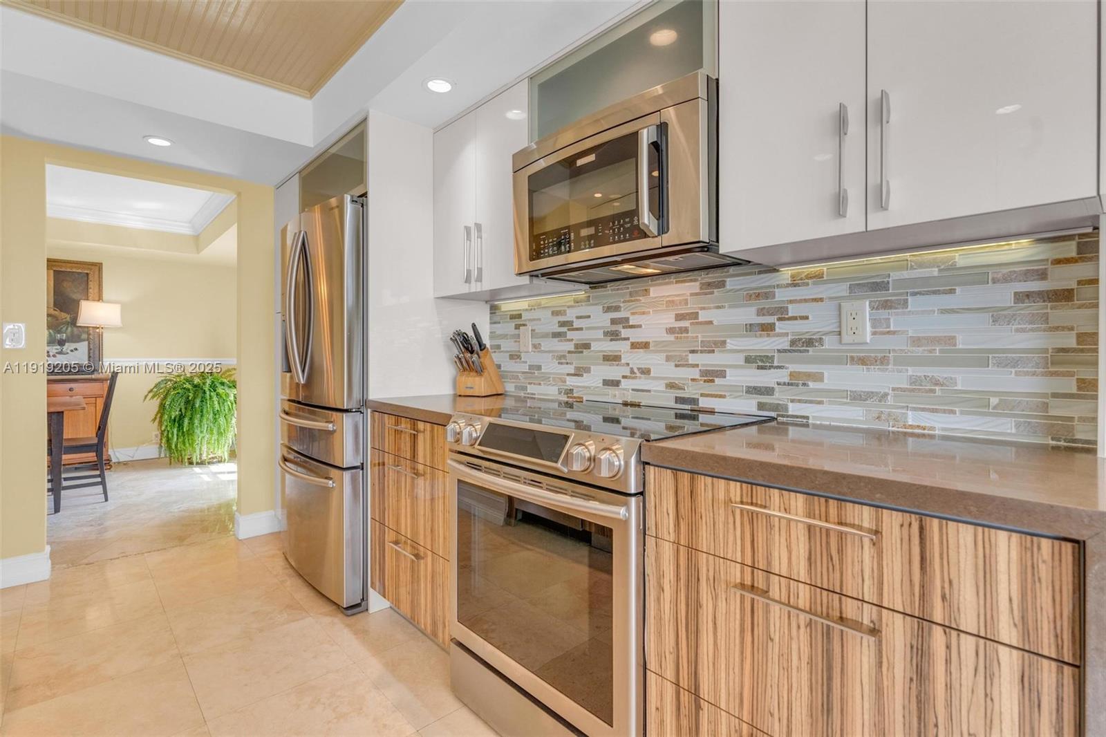 2000 Towerside Terrace, Unit 702 Miami, FL 33138 - Photo 8 of 37 a kitchen with stainless steel appliances granite countertop a refrigerator and a stove top oven