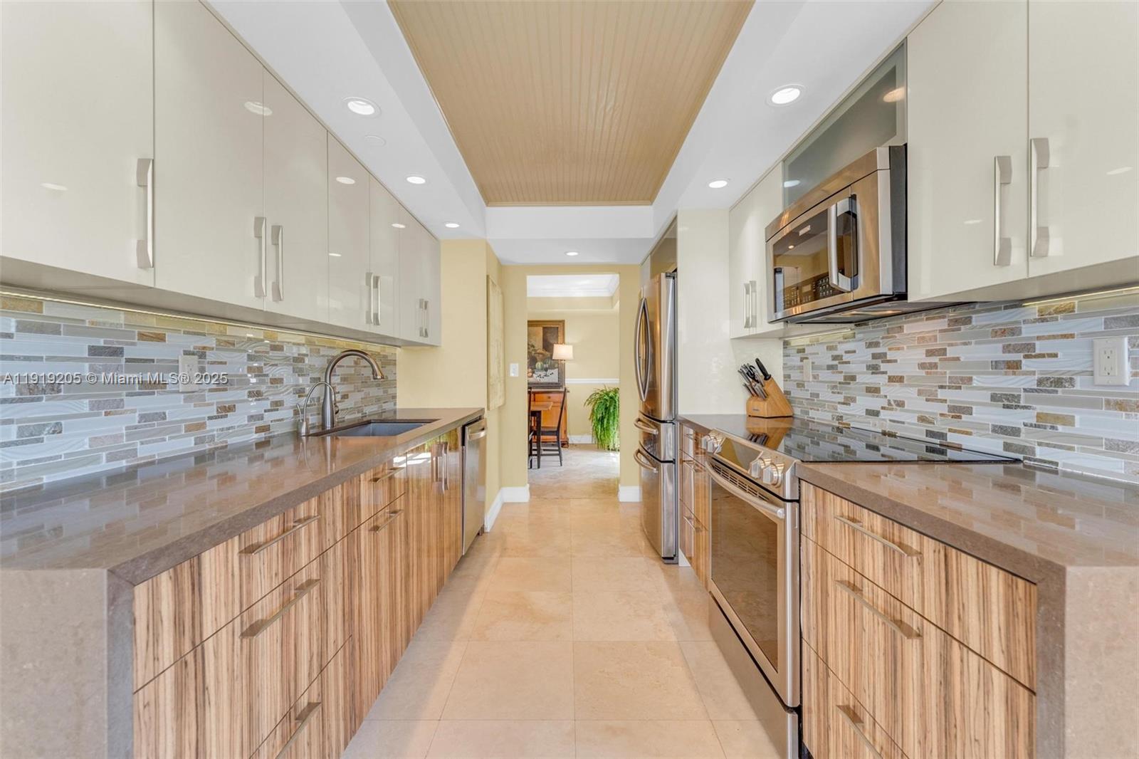 2000 Towerside Terrace, Unit 702 Miami, FL 33138 - Photo 10 of 37 a kitchen with stainless steel appliances granite countertop a sink and stove