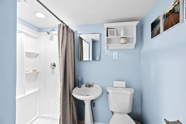 a bathroom with a sink toilet and shower
