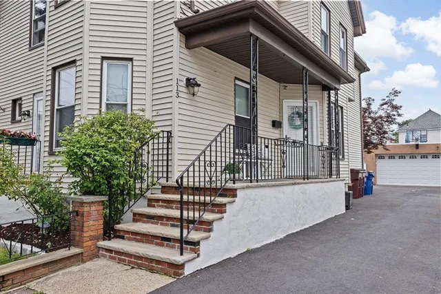 a view of wooden house with a window and potted plants