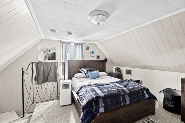 a bedroom with a bed and a mirror