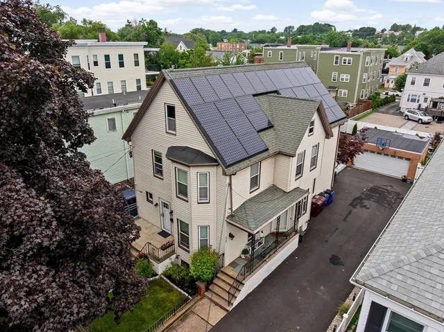 an aerial view of a house with a yard