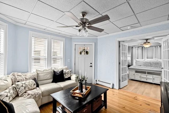 a living room with furniture and wooden floor