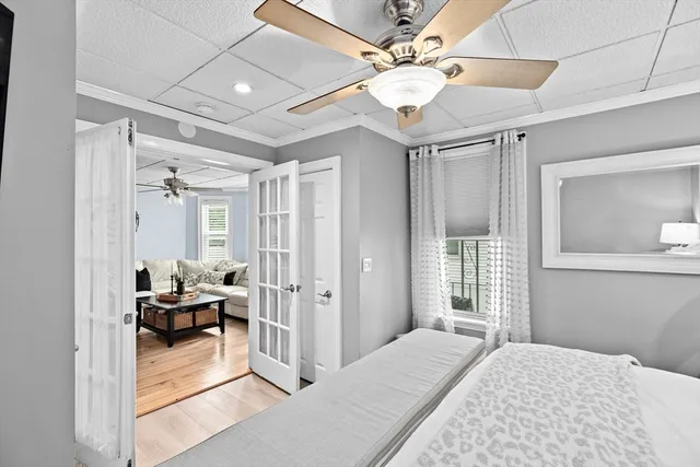 a bedroom with a bed and ceiling fan