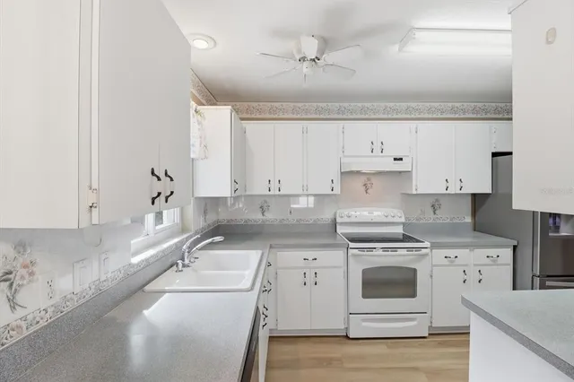 a kitchen with a sink stove and refrigerator