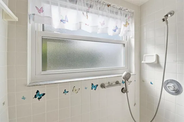 a large white kitchen with a stove a refrigerator and a sink