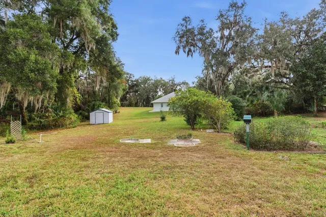 a view of a livingroom with furniture and a book shelf