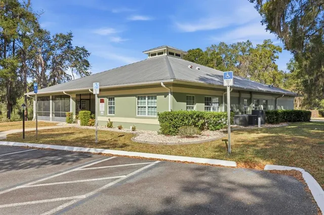 a dining room with furniture water view and a floor to ceiling window