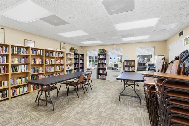 a dining room with furniture and a floor to ceiling window