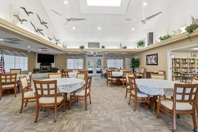 a view of a house with swimming pool and sitting area