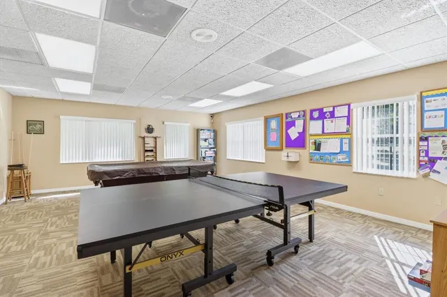 a view of a swimming pool with a yard and sitting area