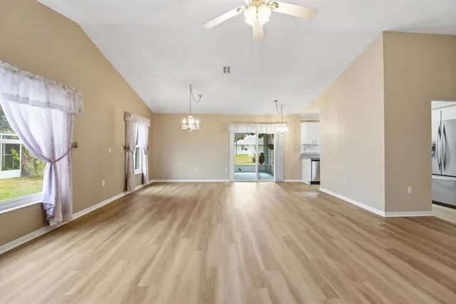 a view of a kitchen with wooden floor and a chandelier