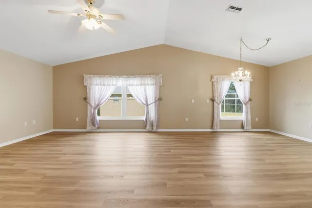 a kitchen with stainless steel appliances granite countertop a sink stove and white cabinets