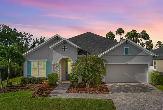 a front view of a house with a yard and garage