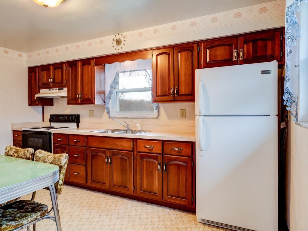 129 Wall Street Rochester, PA 15074 - Photo 3 of 24 a kitchen with a refrigerator a sink and cabinets