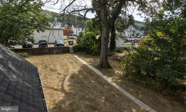 a view of a patio with chair and tables back yard of the house