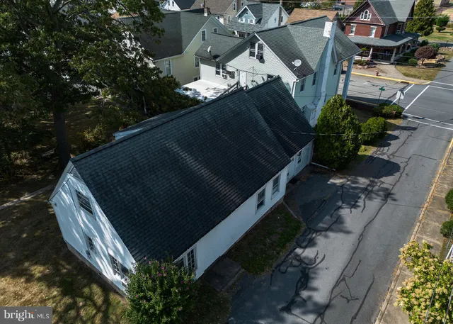 a room with a chair and a refrigerator