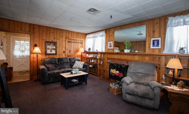 a view of a livingroom with furniture and a window