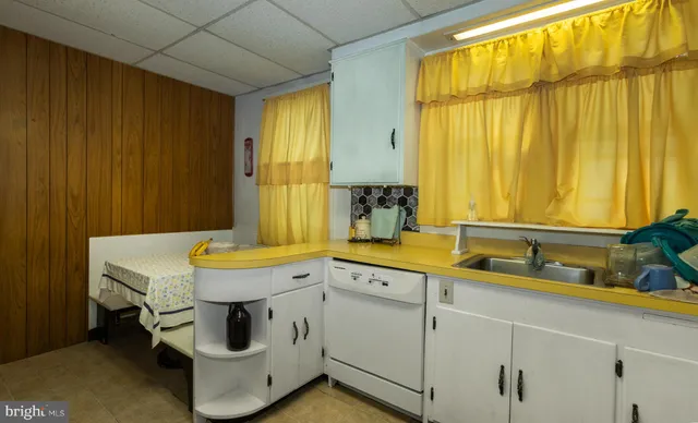 a kitchen with stainless steel appliances granite countertop a stove a sink dishwasher and cabinets with wooden floor